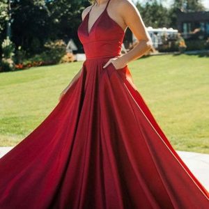 Elegant Red V-Neck Evening Gown with Pockets and Flowing Skirt